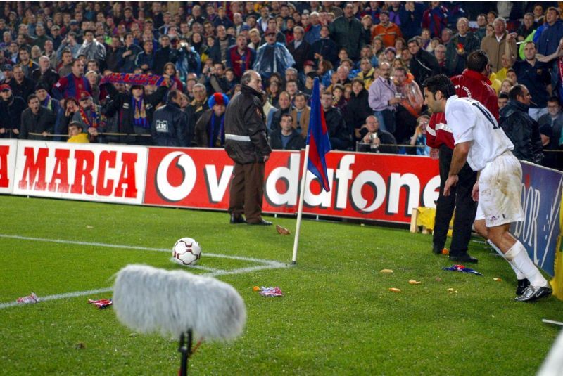 Luis Figo of Real Madrid is bombarded by missiles as he attempts to take a corner against Barcelona