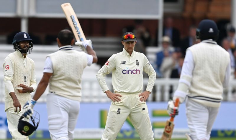 Joe Root watches as Mohammed Shami celebrates a Test fifty.