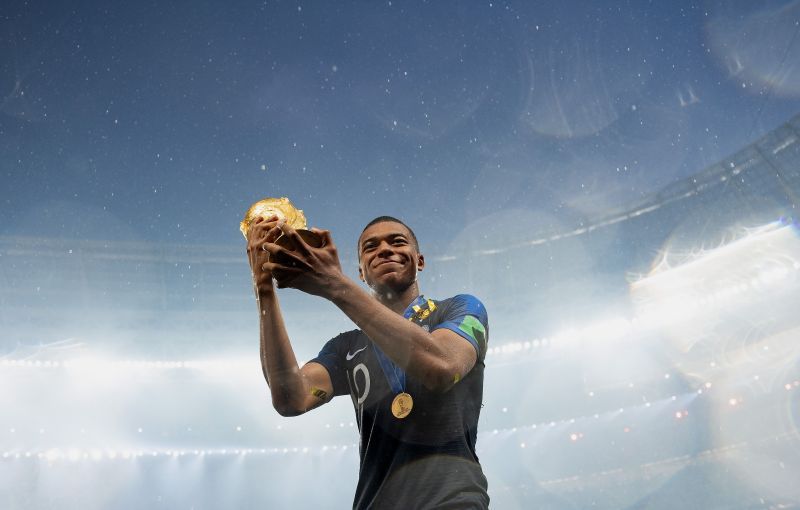 Kylian Mbappe celebrating the 2018 FIFA World Cup trophy
