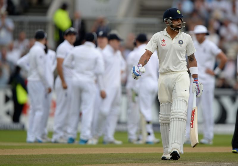 Virat Kohli falls during the 2014 Manchester Test.