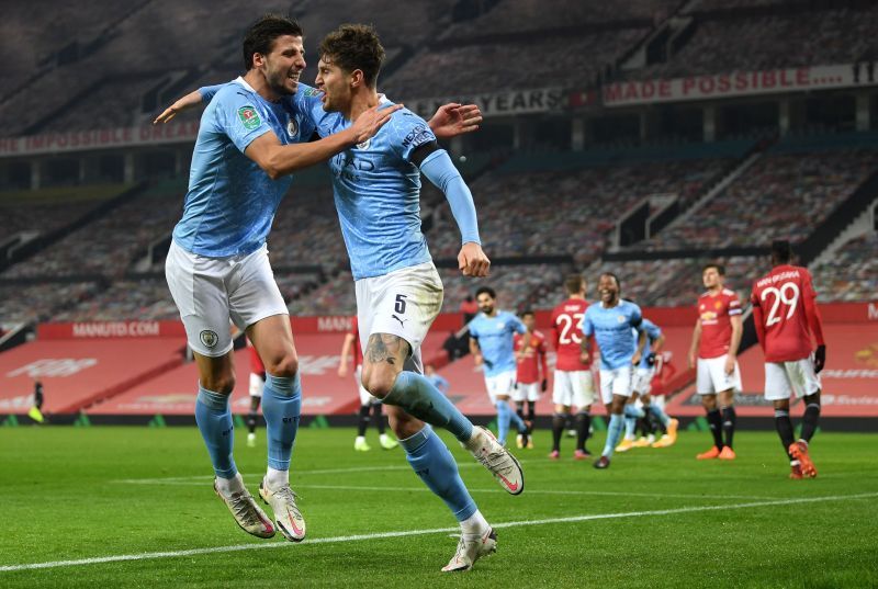 Ruben Dias (left) and John Stones (right) celebrate a goal