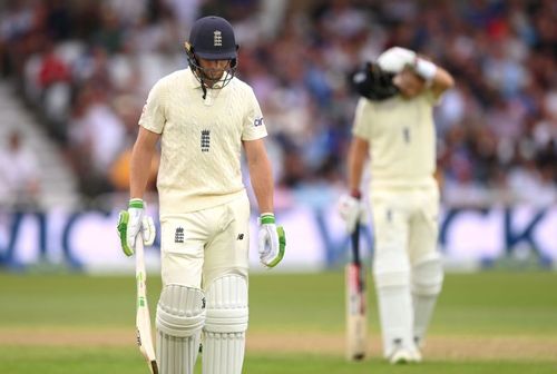 A dejected Jos Buttler walks off the field.