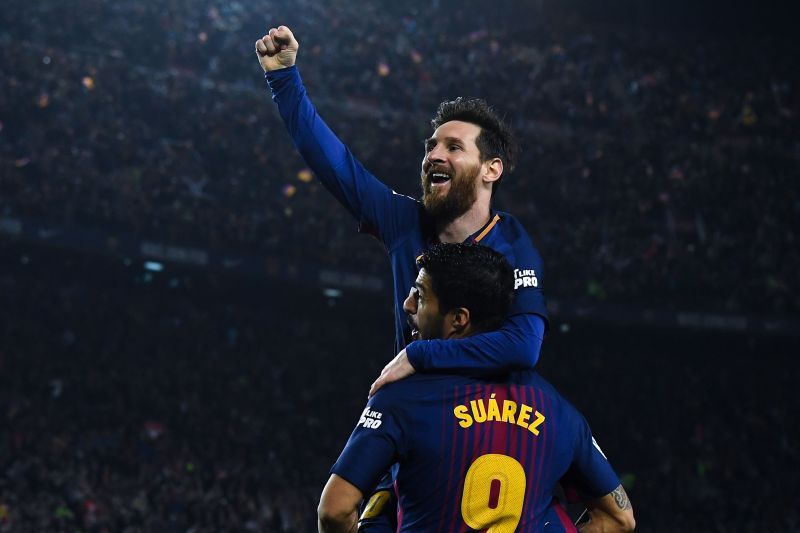 Lionel Messi celebrates with Luis Suarez after scoring his team's second goal