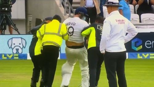 Daniel Jarvis aka 'Jarvo 69' being taken off the ground by stadium security at the Emerald Headingley Cricket Ground in Leeds, England