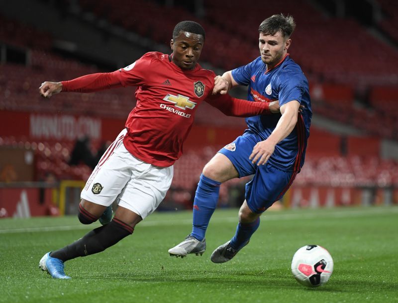 Ethan Laird (L) featured for MK Dons in the Championship in the 2020-21 season. 