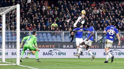 Cristiano Ronaldo leaping above defenders to head the ball home for Juventus