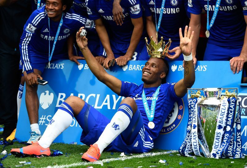 Didier Drogba celebrating with the Premier League trophy