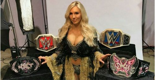 Charlotte Flair posing all of her singles Women's Championships