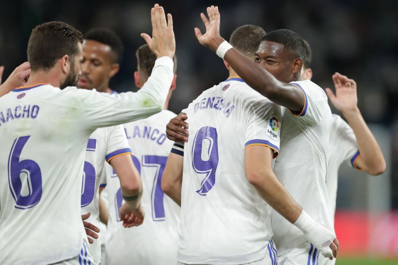 Real Madrid players celebrate after scoring a goal.