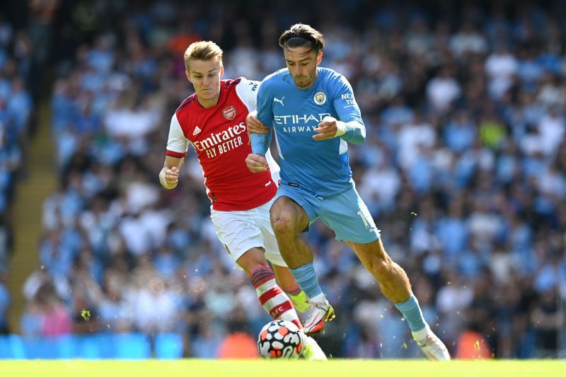 Manchester City&#039;s Jack Grealish and Arsenal&#039;s Martin Odegaard fight for the ball