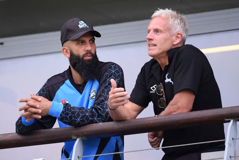 Former England cricket team coach Peter Moores (right) with Moeen Ali