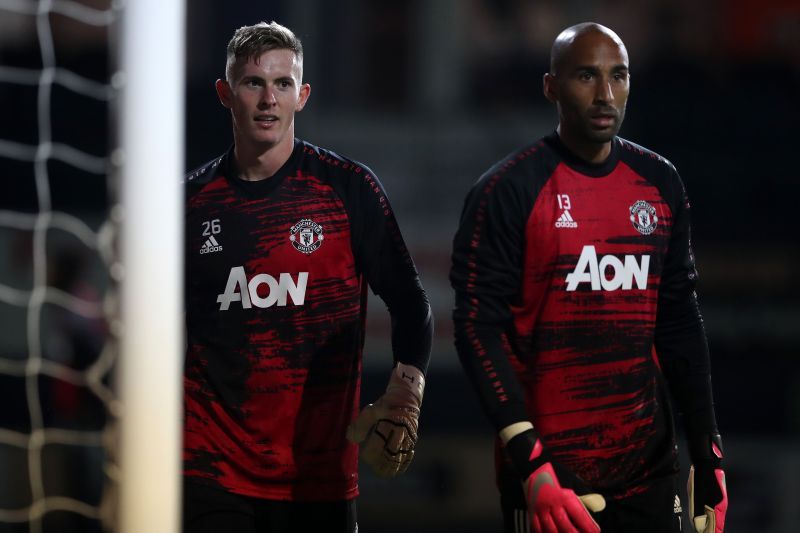 Grant (right) is often seen talking to young goalkeepers in Man Utd camp