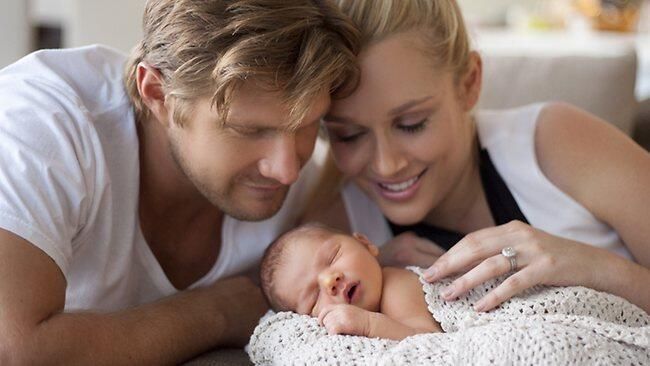 Shane Watson with his child and his wife
