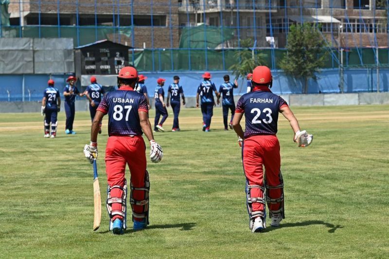 Afghanistan cricketers Usman and Farhan walk out into the middle