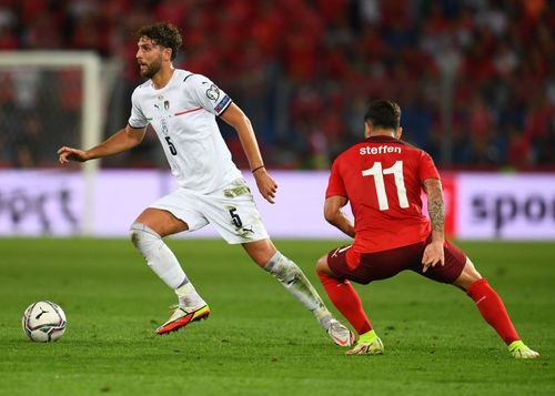 Italy's Manuel Locatelli (left) in action during his side's 2022 FIFA World Cup Qualifier against Switzerland