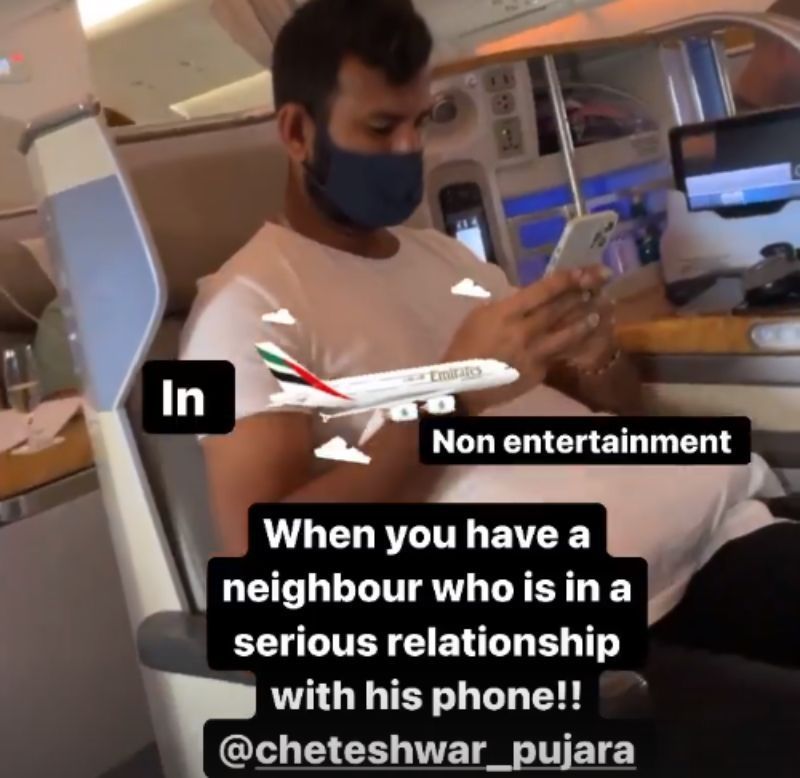 Cheteshwar Pujara is busy on his phone.