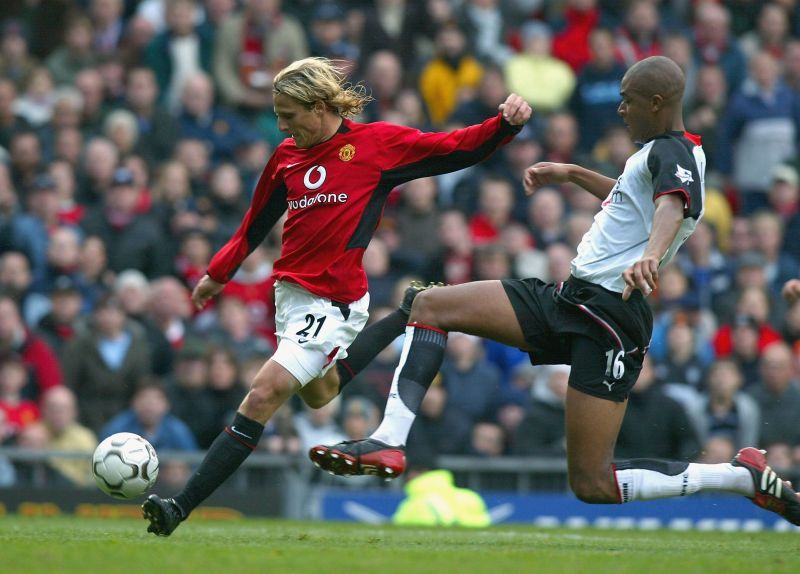 Diego Forlan of United gets past Zat Knight of Fulham to score