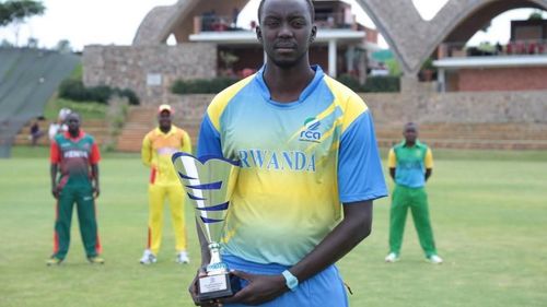 A Rwanda Cricket Team Player posing with a trophy