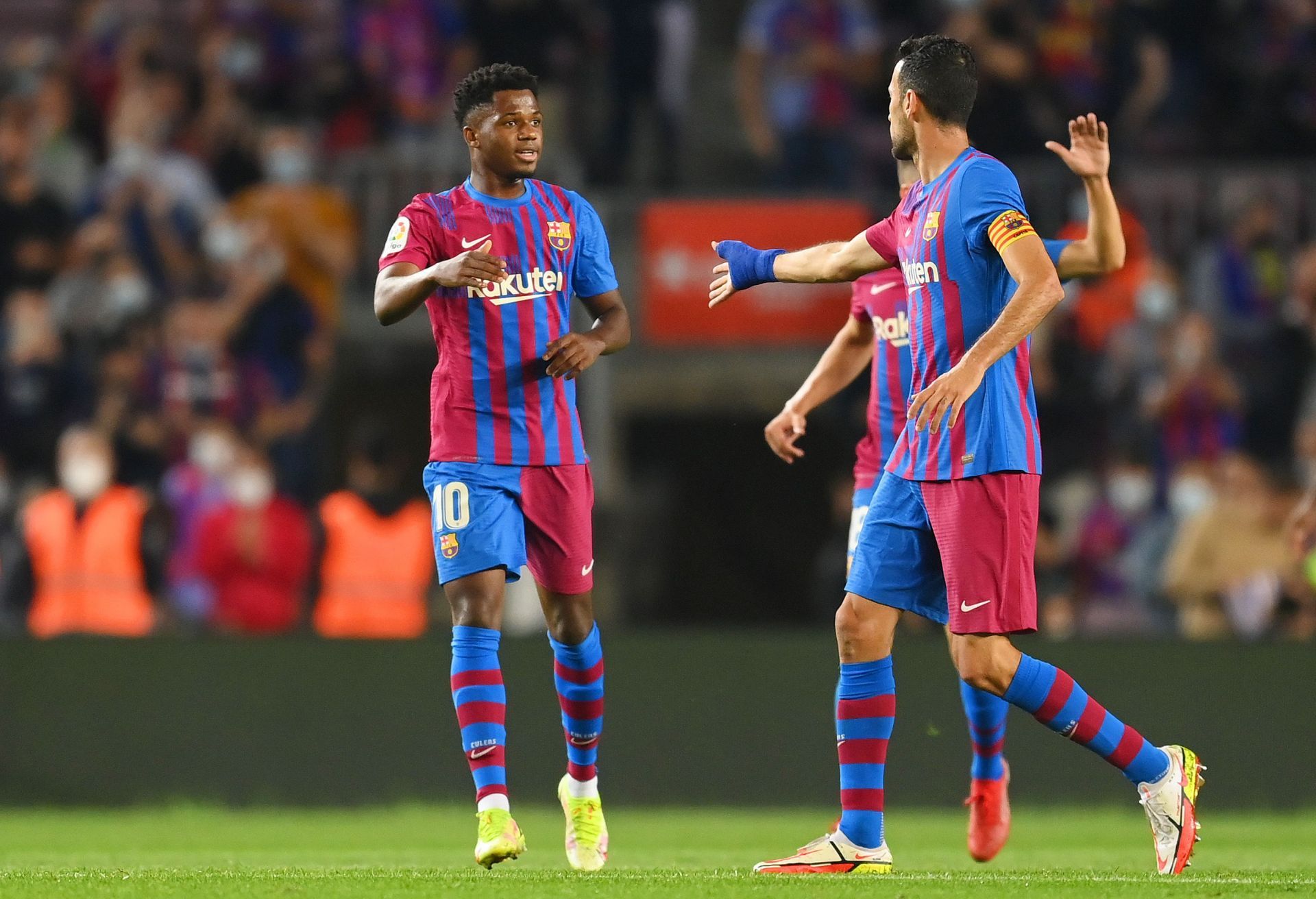 Fati and Busquets congratulating together