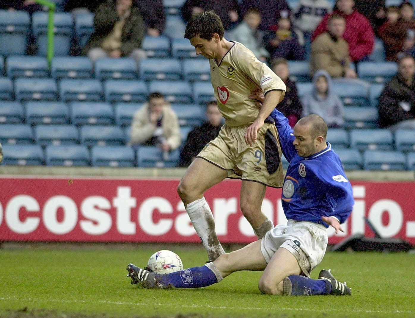 Svetoslav Todorov of Portsmouth is tackled by Robbie Ryan of Millwall