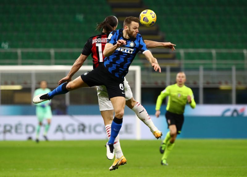 Inter Milan defender Stefan De Vrij fights for an aerial ball.