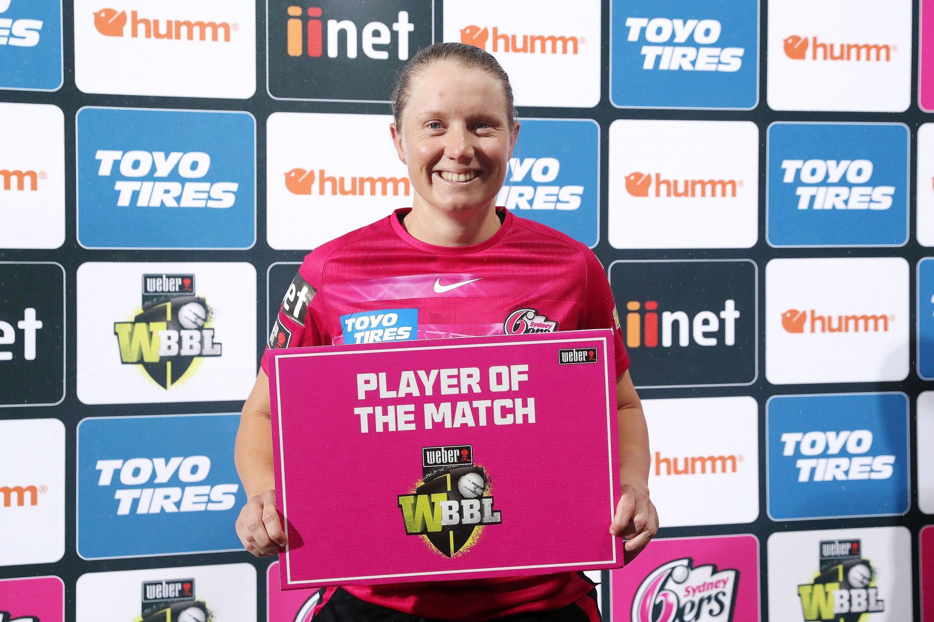 Alyssa Healy posing with the Player of the Match award