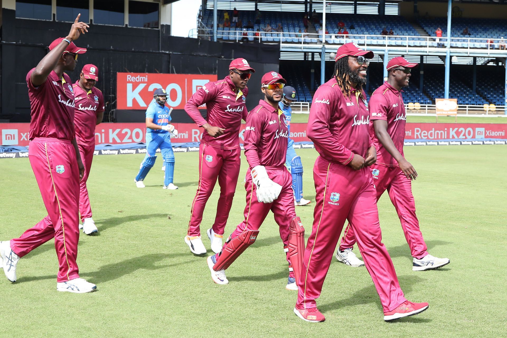 The West Indies men&#039;s cricket team walk out on to the pitch.