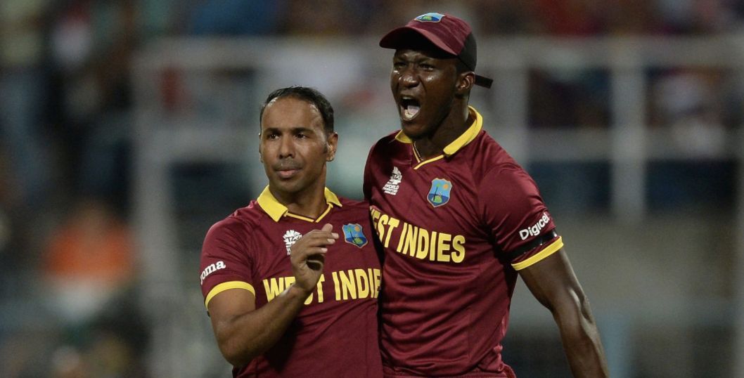 Samuel Badree and Darren Sammy celebrate Jason Roy&#039;s wicket in the 2016 World Cup final.