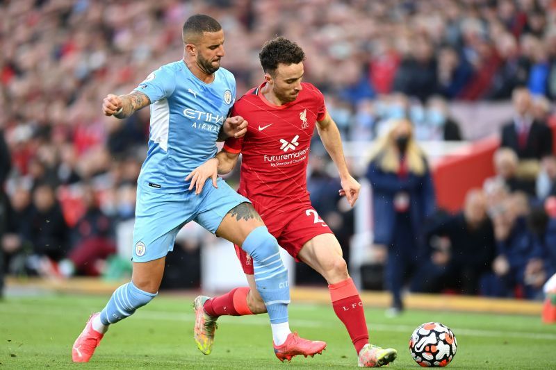 Manchester City's Kyle Walker (left) attempts to tackle Liverpool's Diogo Jota.