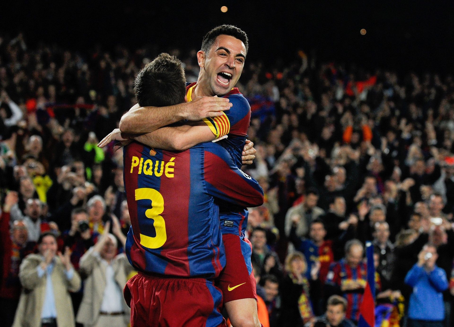 Xavi and Pique celebrating a goal