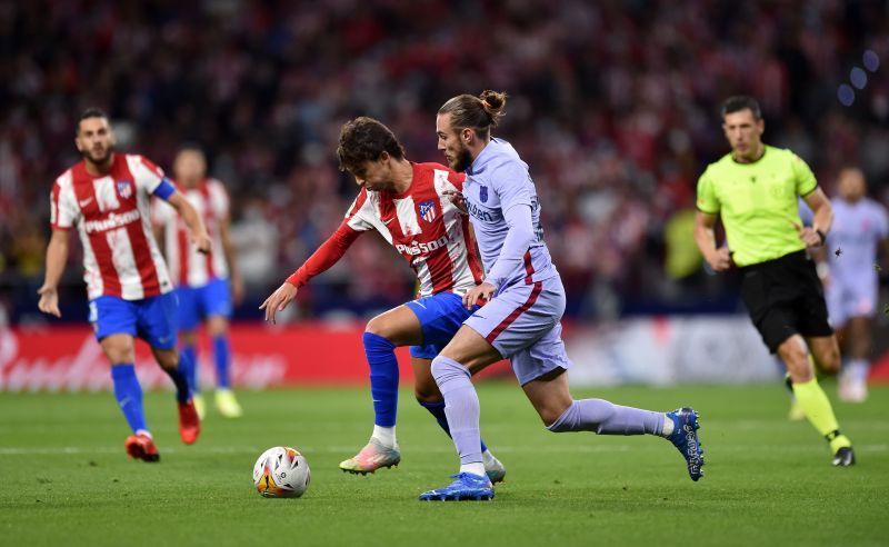 Atletico Madrid's Joao Felix dribbles past Barcelona's Oscar Mingueza.