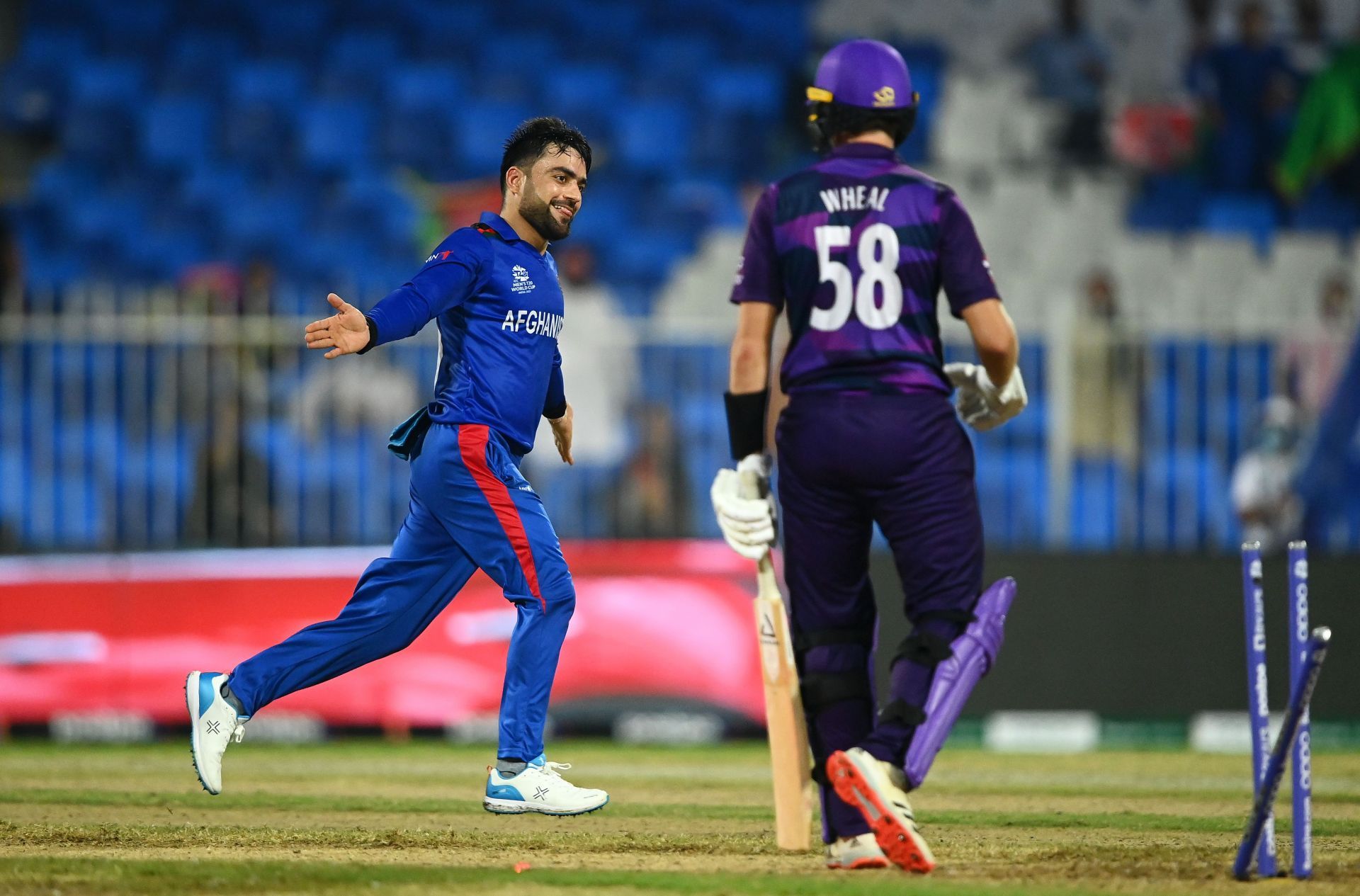 Afghanistan&#039;s Rashid Khan (left) celebrates a wicket.