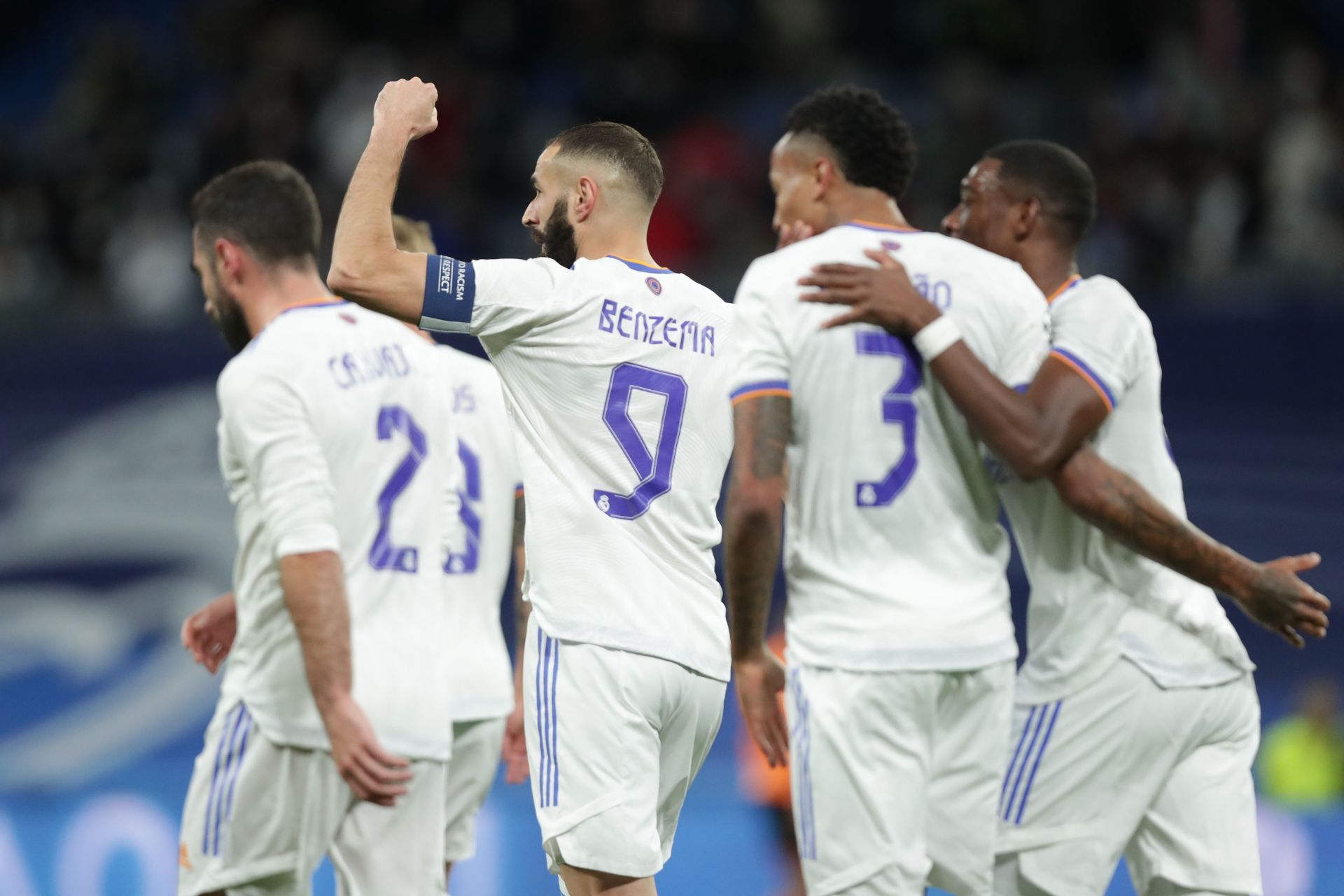 Real Madrid players celebrate after scoring a goal against Sevilla.
