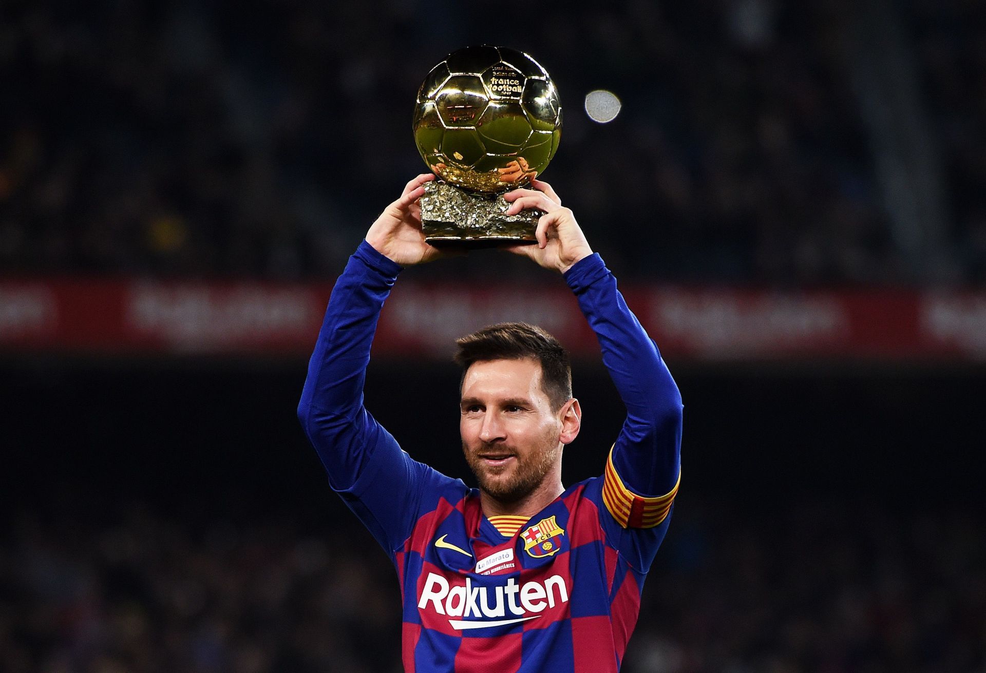 Lionel Messi shows off his Ballon d&#039;Or award to the Camp Nou in 2019.