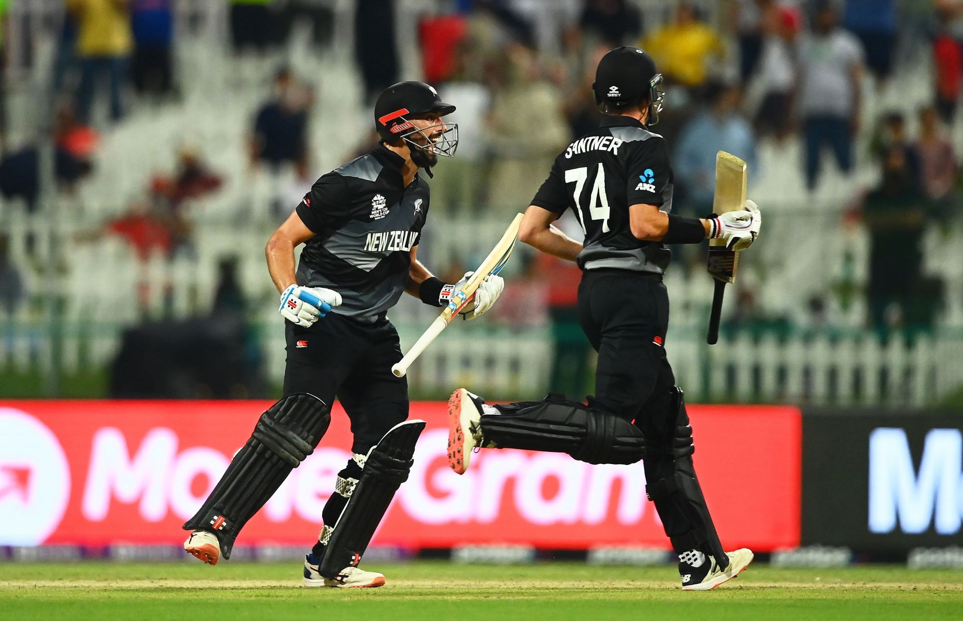 Daryl Mitchell (left) celebrates with Mitchell Santner after New Zealand&rsquo;s semi-final win. Pic: Getty Images