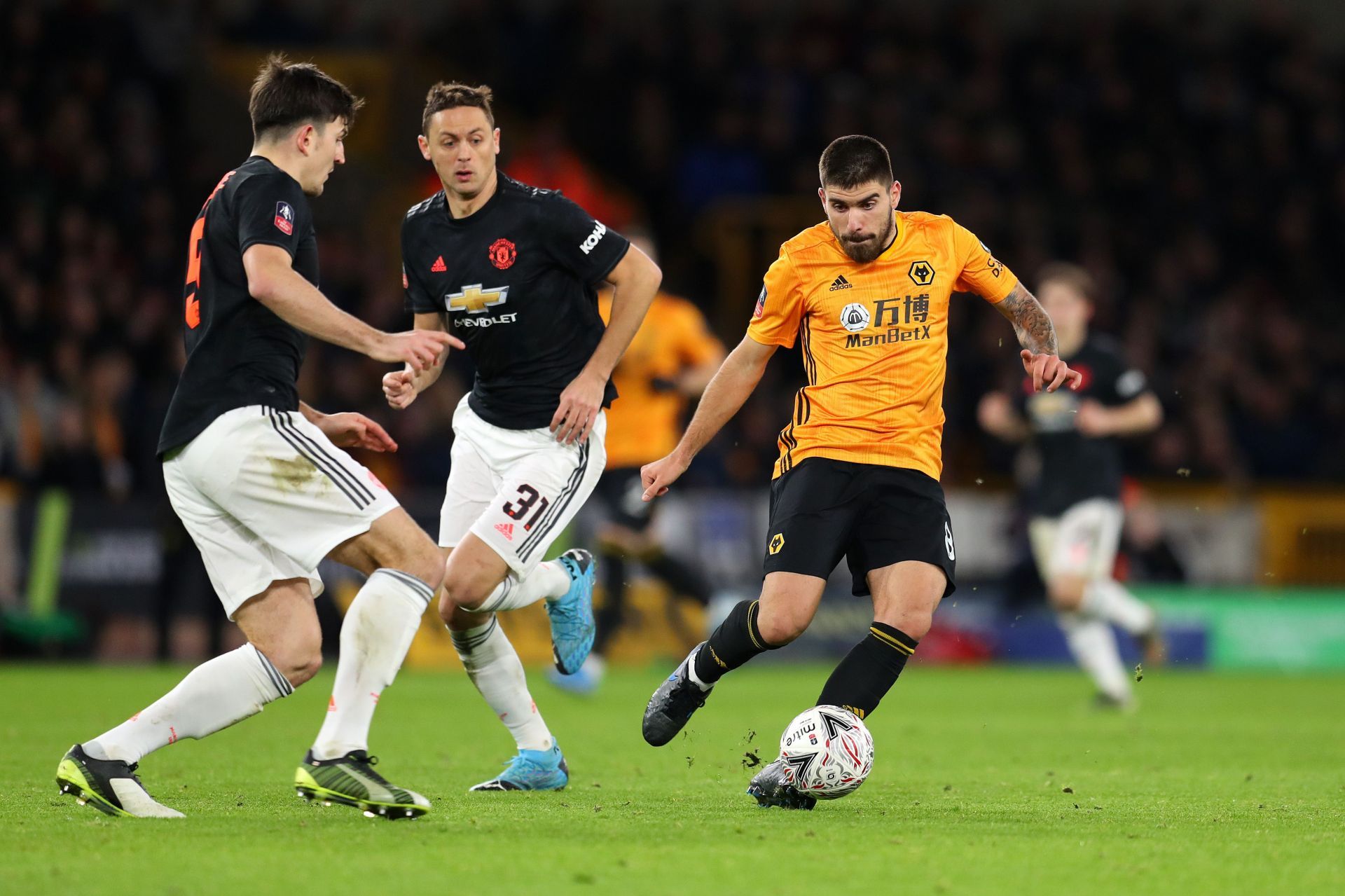 Could Ruben Neves (right) join Harry Maguire (left) and Nemanja Matic (#31) at Manchester United?