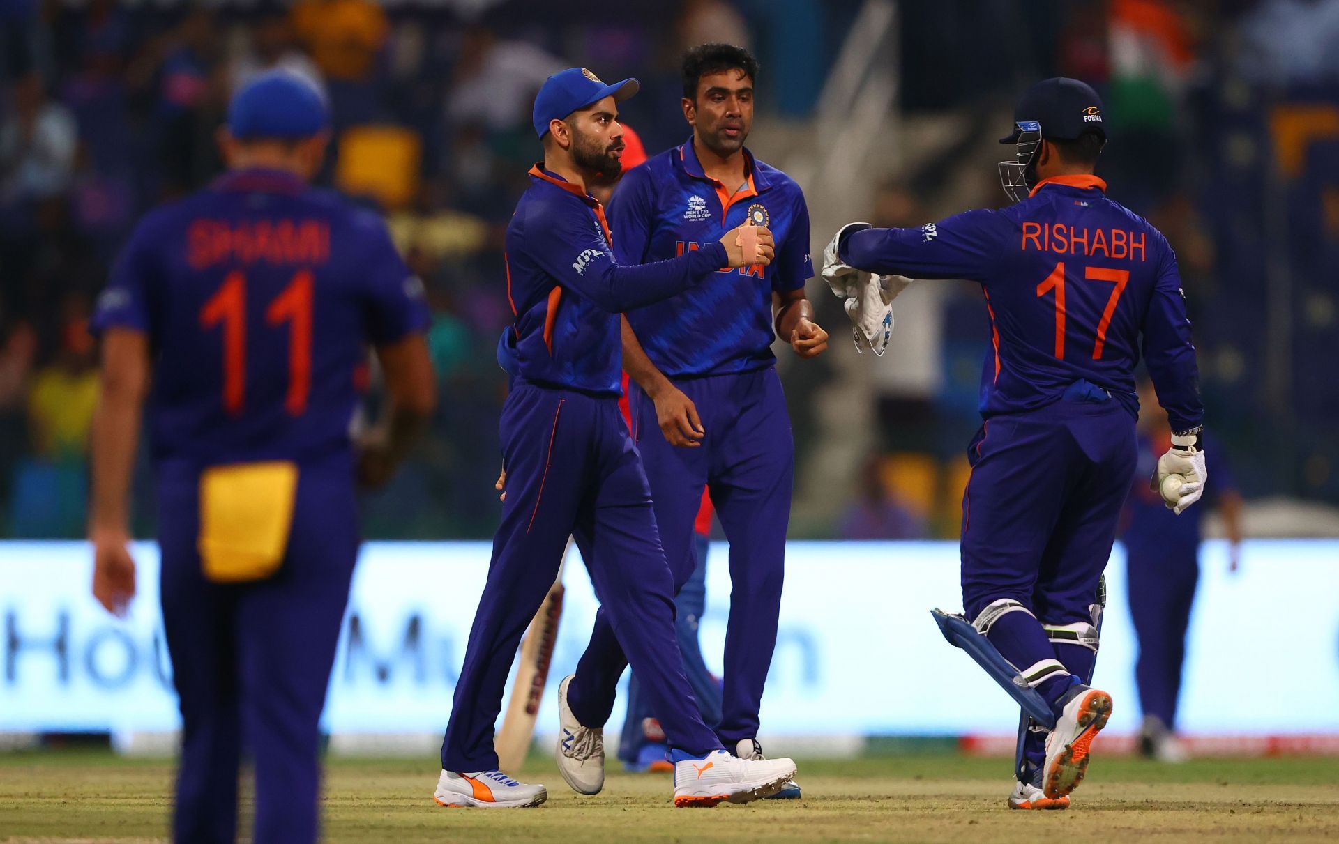 R Ashwin celebrates the wicket of Najibullah Zadran with teammates. Pic: Getty Images