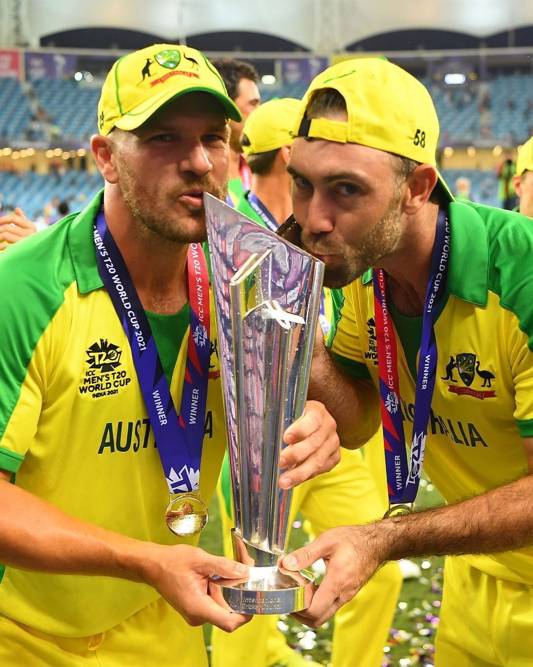 Glenn Maxwell and Aaron Finch kissing the elusive trophy
