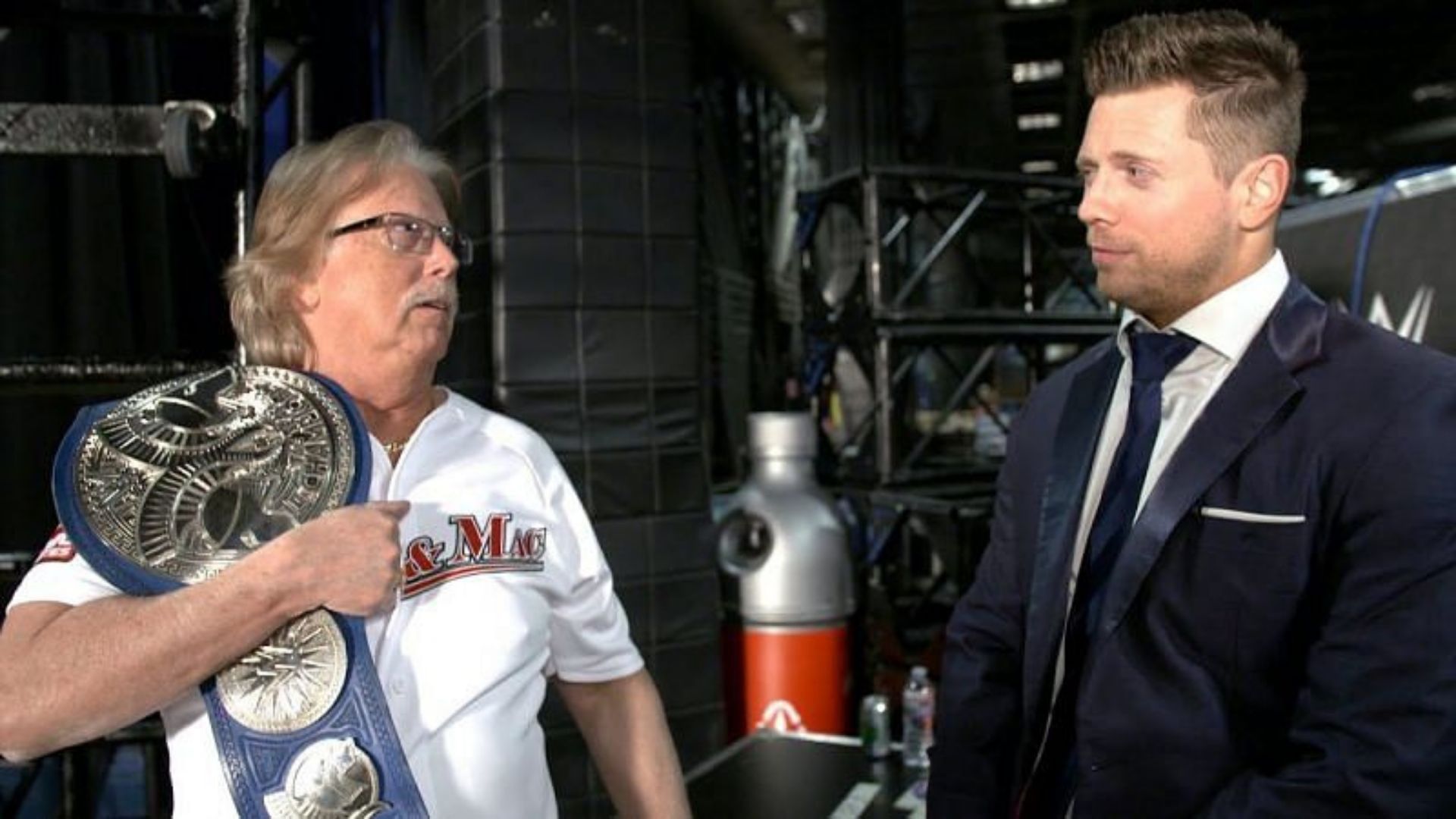 George Mizanin backstage on SmackDown with the tag team title belt.