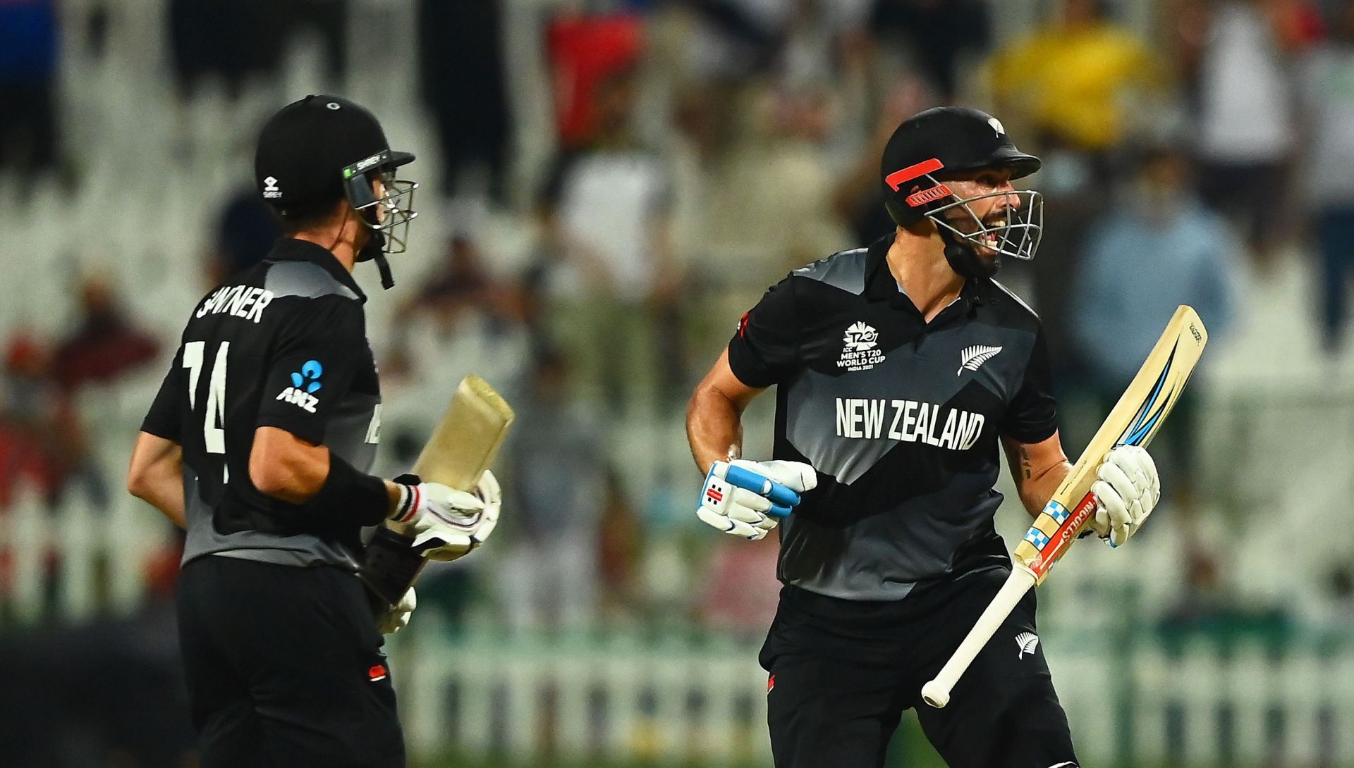 Daryl Mitchell (R) celebrates with Mitchell Santner after New Zealand&rsquo;s semi-final win over England. Pic: Getty Images