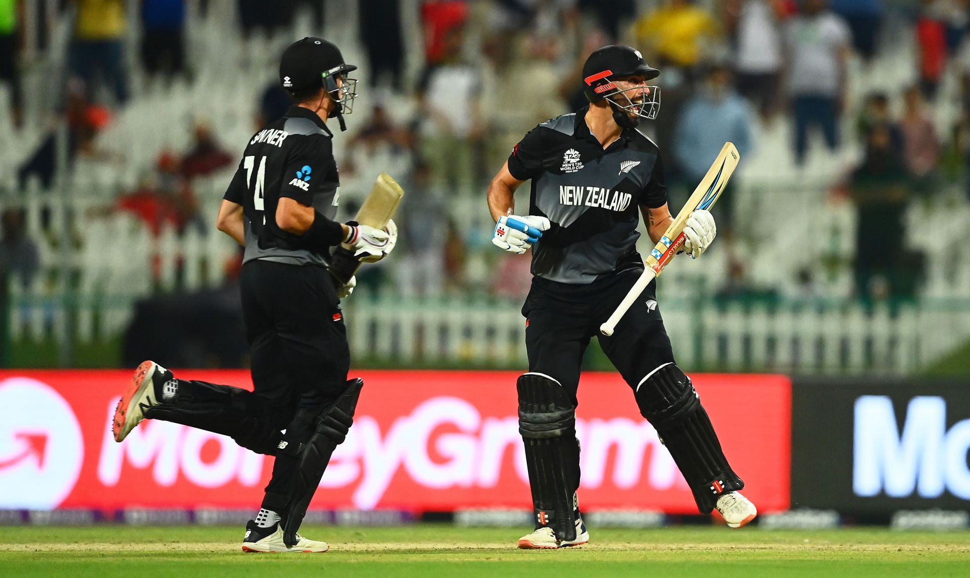 Daryl Mitchell celebrates with Mitchell Santner following New Zealand&rsquo;s win over England. Pic: Getty Images