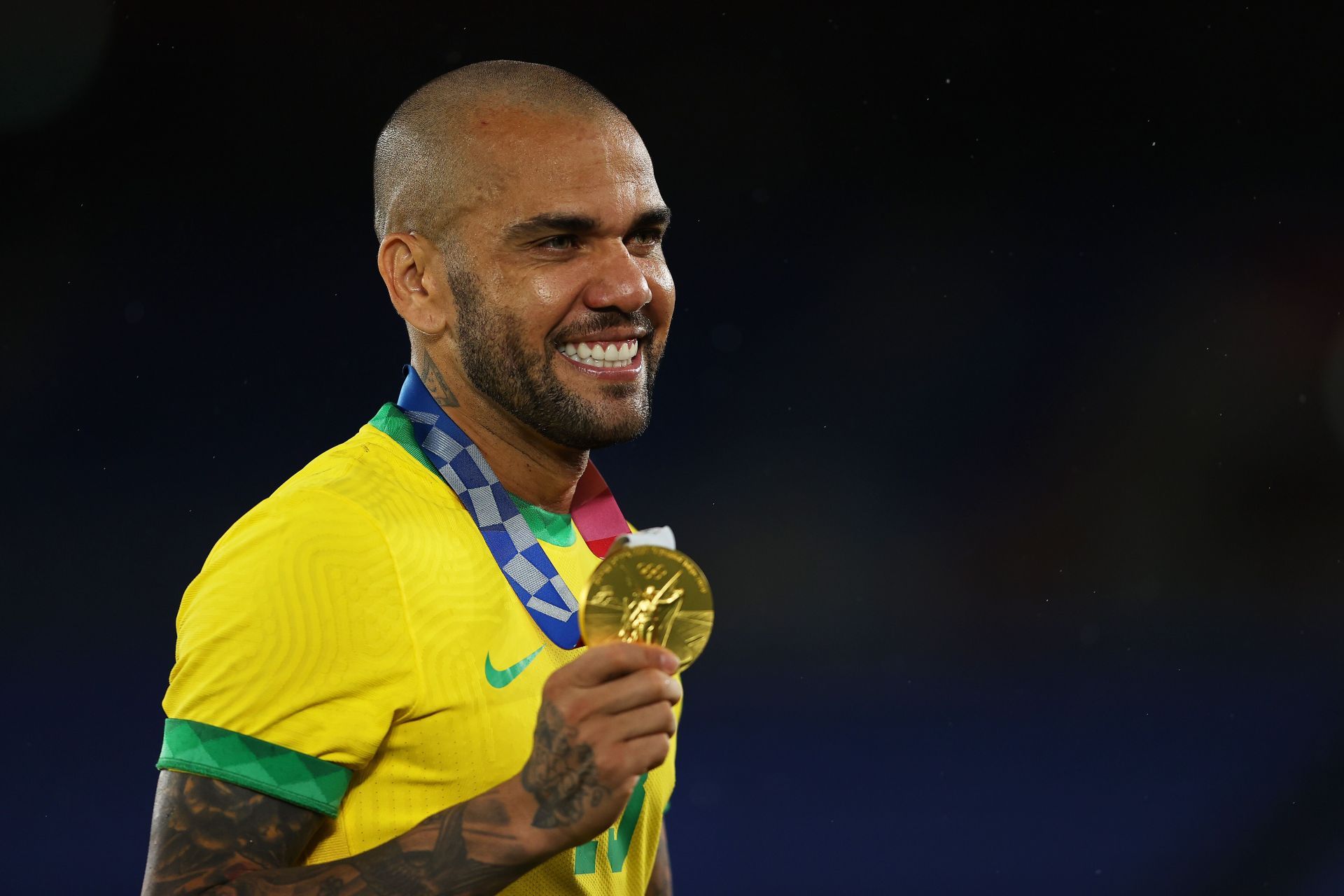 Dani Alves proudly shows off his gold medal at the 2020 Tokyo Olympics.