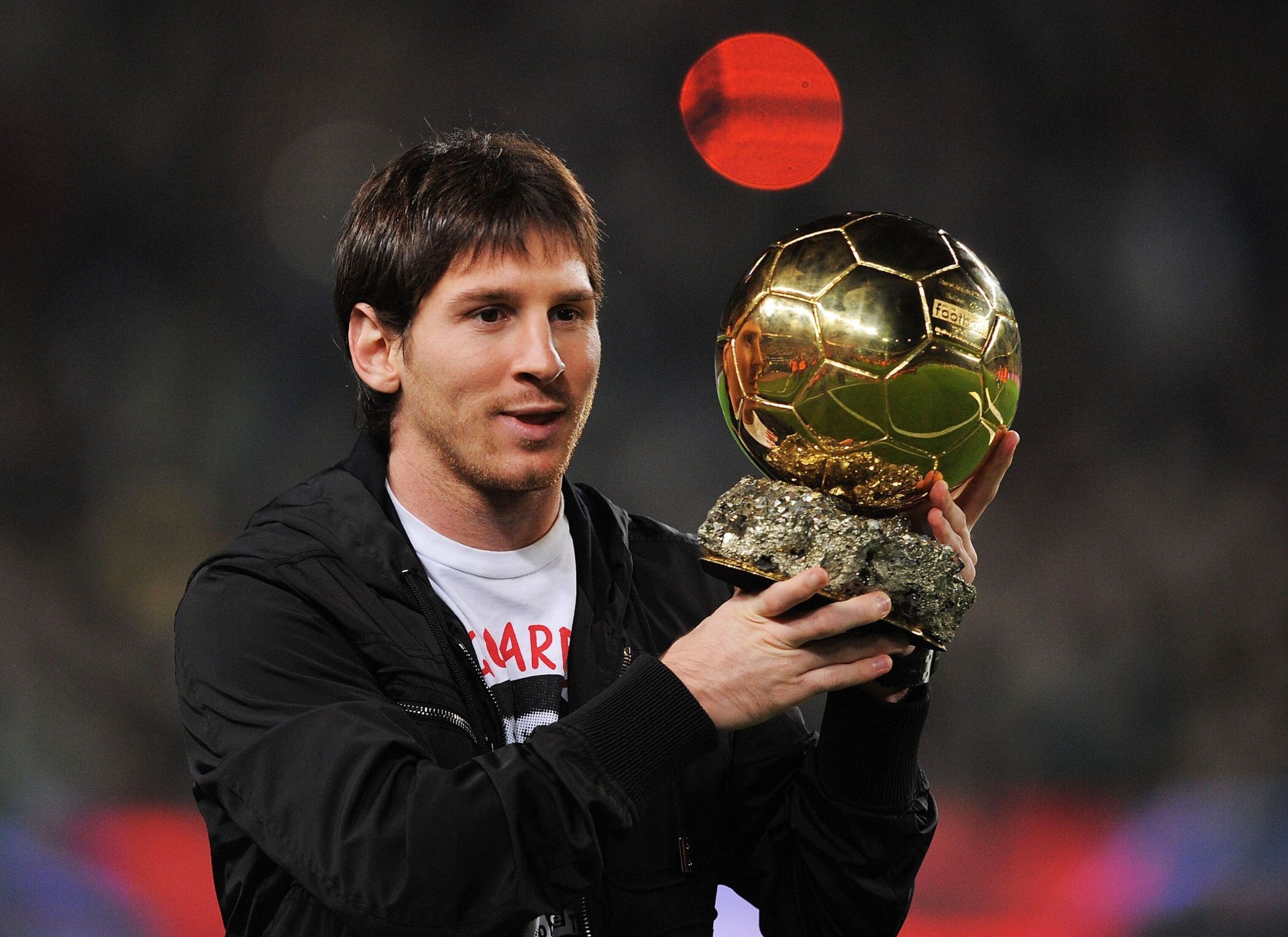 Lionel Messi shows off his first Ballon d'Or award in 2009.