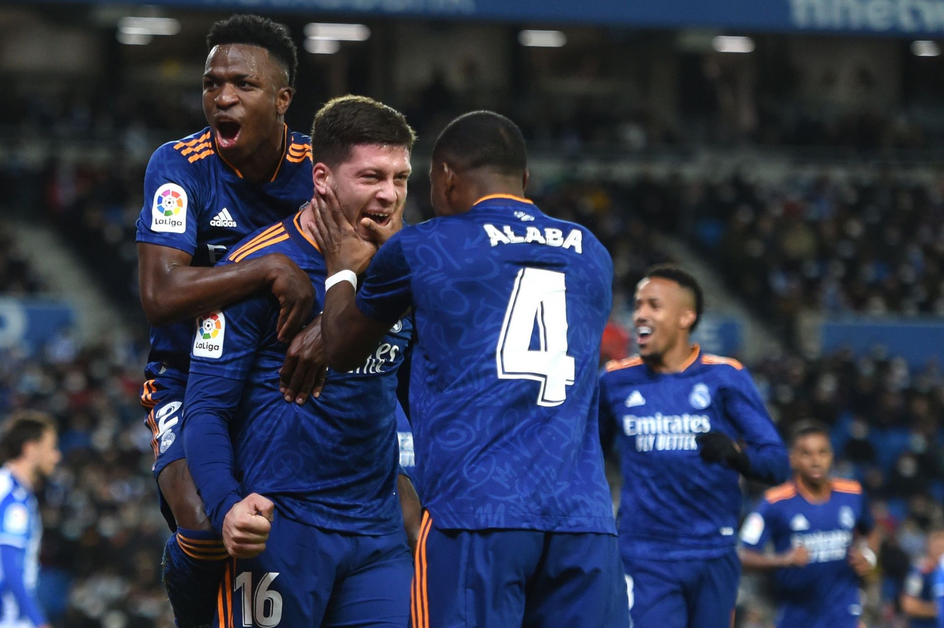 Real Madrid players rejoice after scoring a goal.