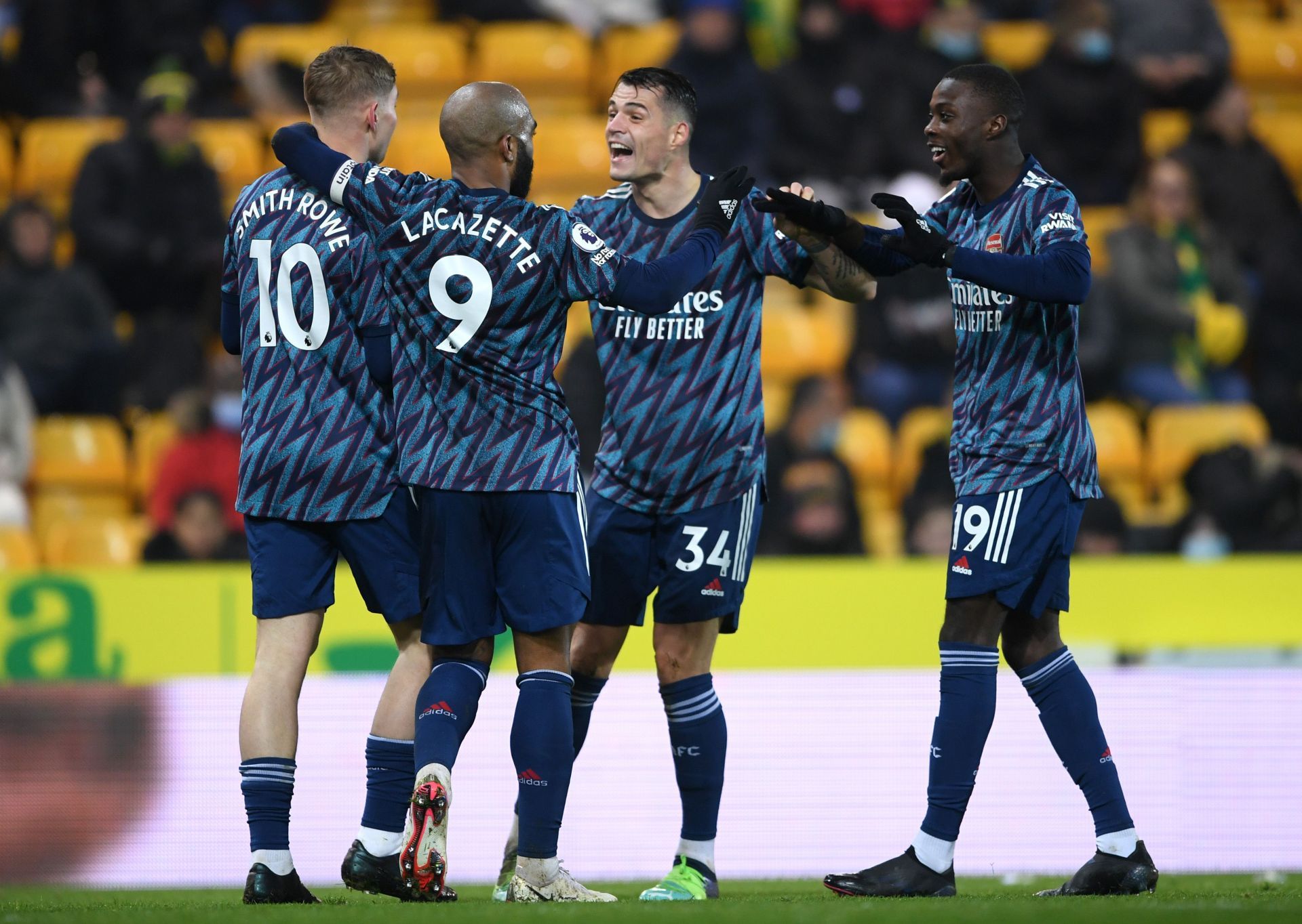 Arsenal players celebrate after scoring against Norwich City.