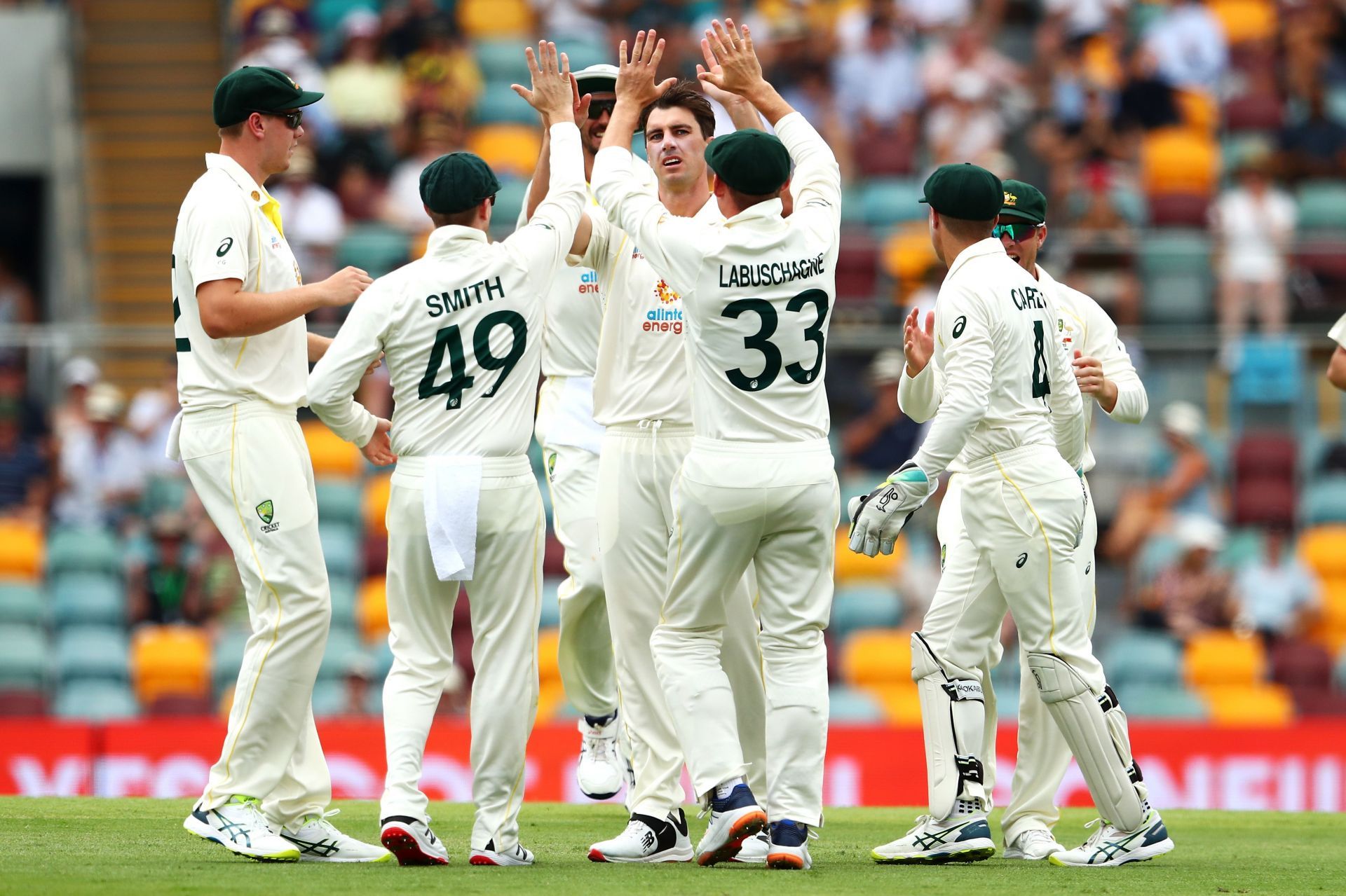 Pat Cummins celebrates with his team after taking the wicket of Rory Burns. Pic: Getty Images