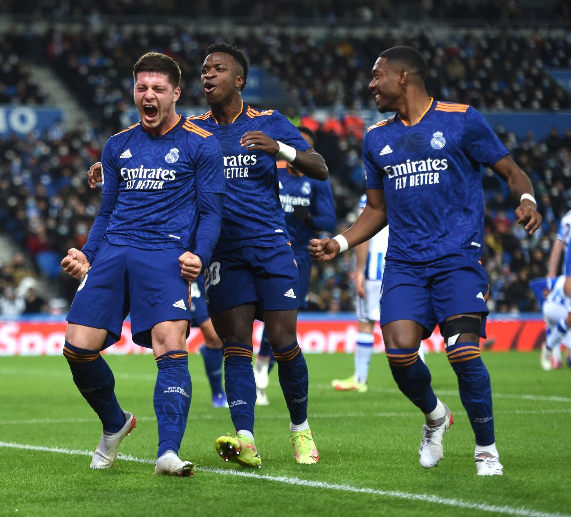 Real Madrid players celebrate after scoring a goal.