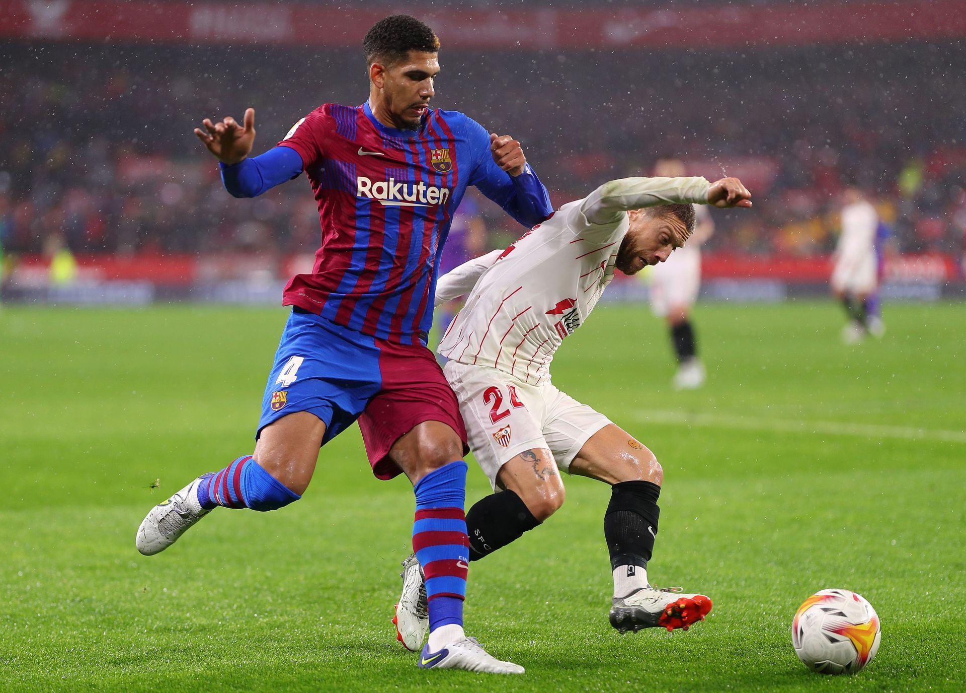 Ronald Araujo of Barcelona battles for possession with Alejandro Gomez of Sevilla 