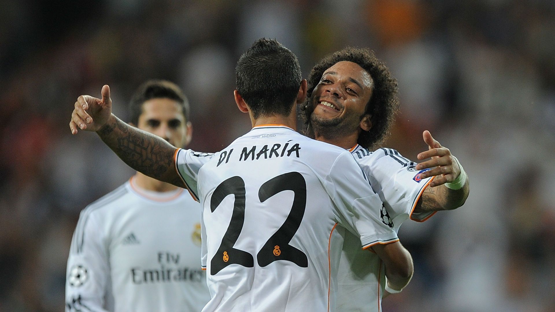 Angel Di Maria (#22) and Marcelo embrace in celebration after a Real Madrid goal.