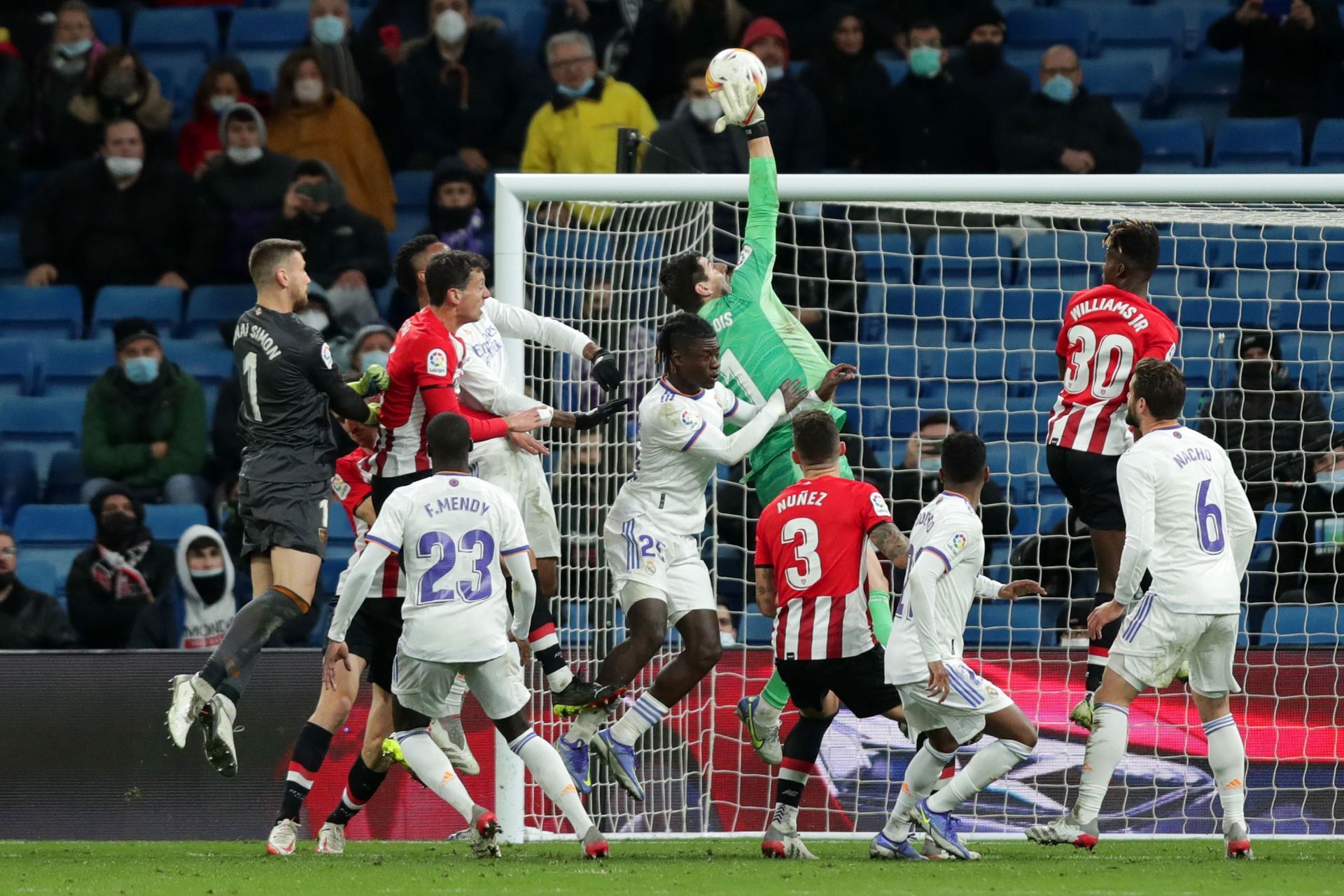 Thibaut Courtois diverts the ball away from goal.